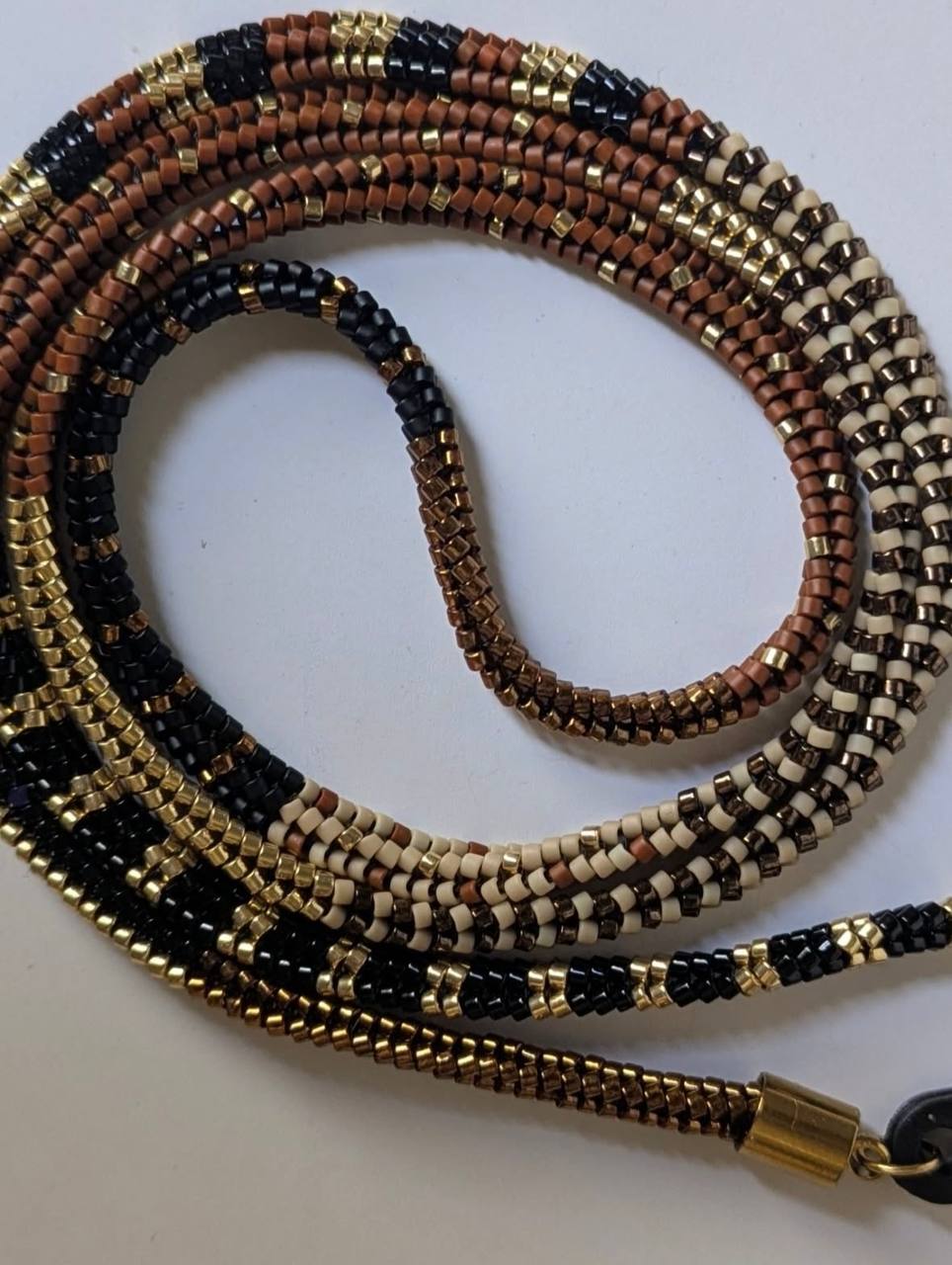 Close-up of tubular Miyuki bead glasses chain with stainless steel details