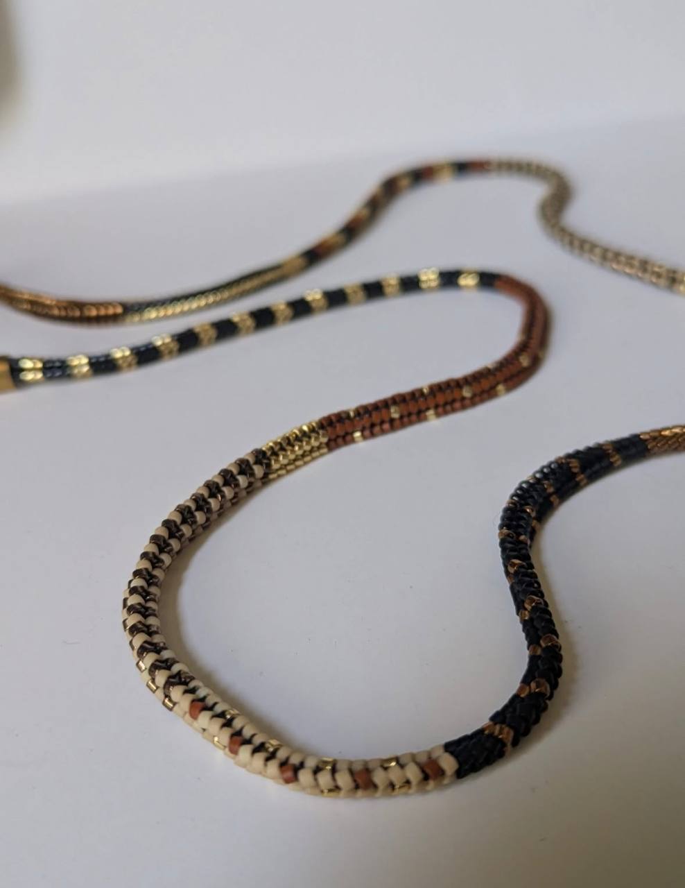 Close-up of tubular Miyuki bead glasses chain with stainless steel details