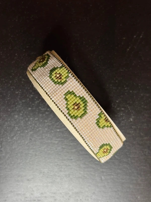 Small rectangular pouch with avocado pattern on a dark surface