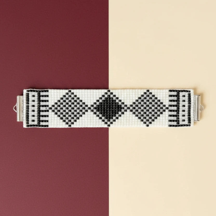 Black and white patterned bracelet on a black and white background