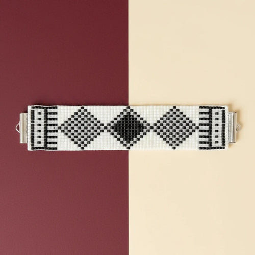 Black and white patterned bracelet on a black and white background