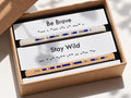 Two beaded bracelets with motivational phrases in a box