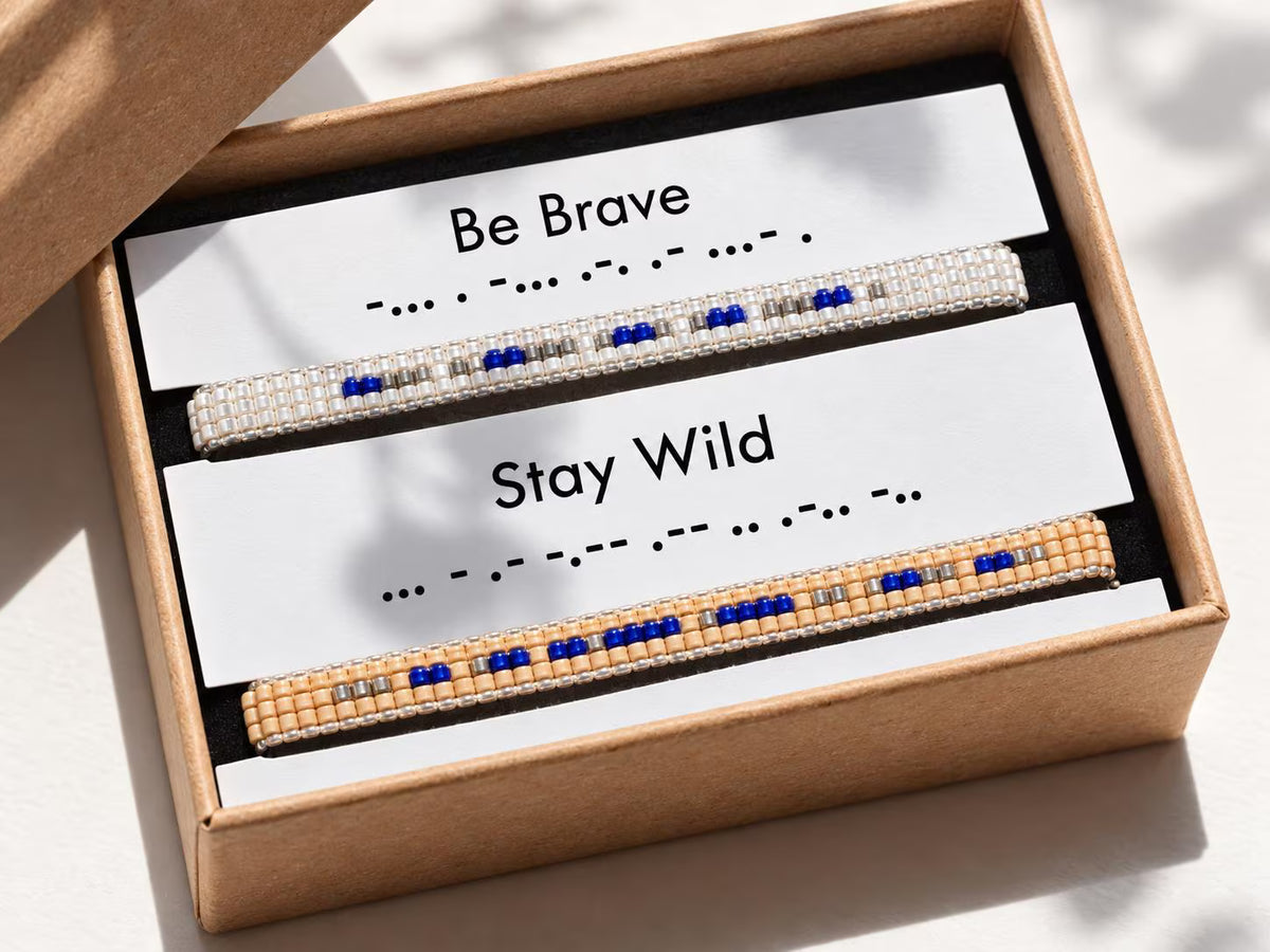Two beaded bracelets with motivational phrases in a box