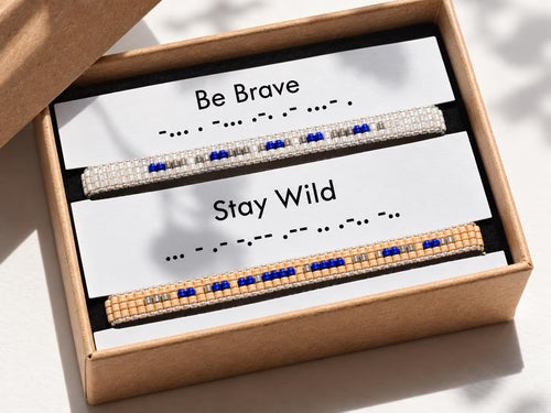 Two beaded bracelets with motivational phrases in a box