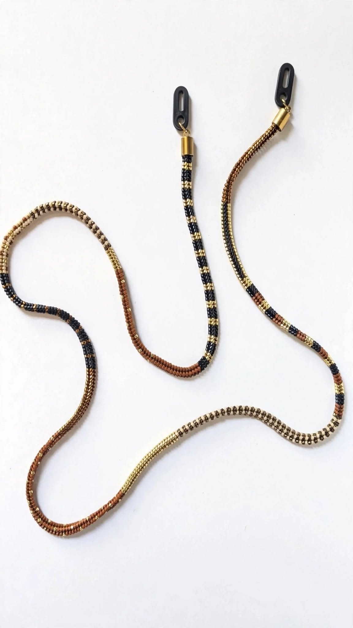 Two beaded necklaces with black, gold, and brown beads, displayed on a plain white background.